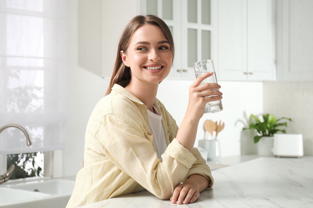 woman with glass of water at counter